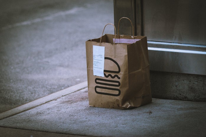 food delivery bag outside door by Jon Tyson via Unsplash?width=698&height=466&fit=crop&auto=webp