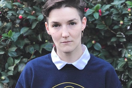 person in front of flower bush