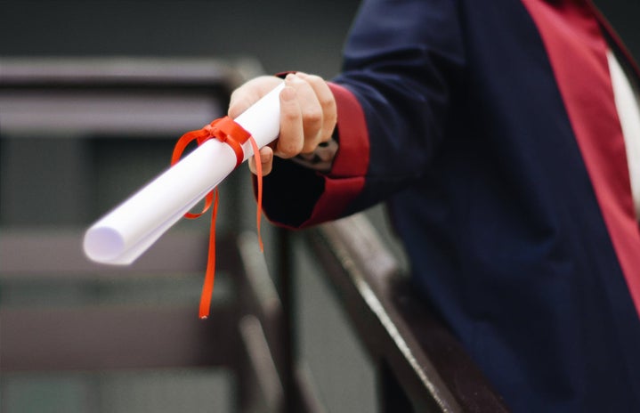 Person holding white scroll