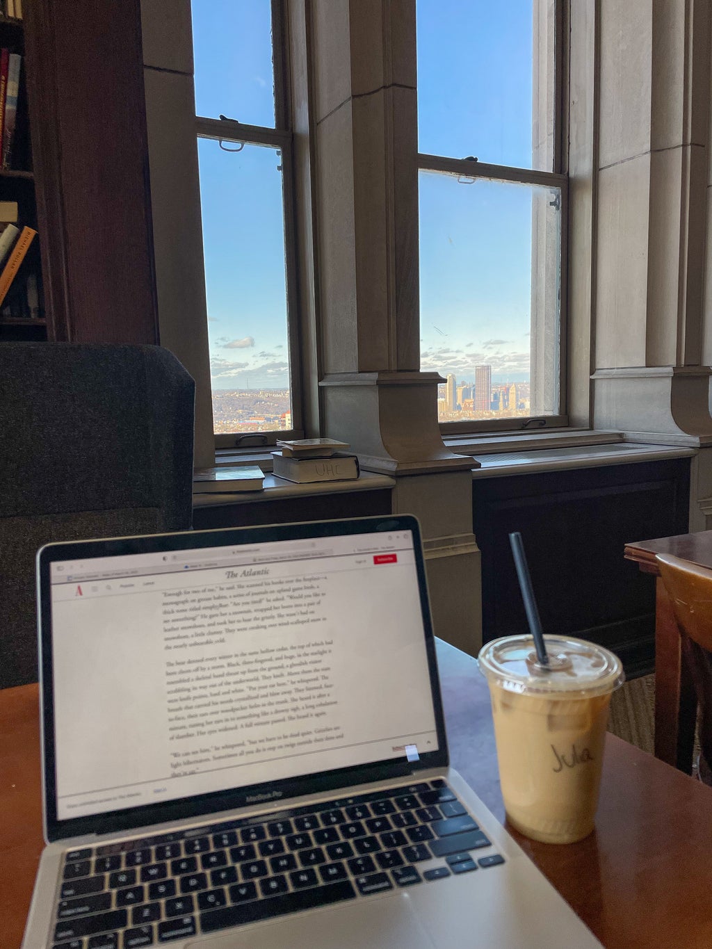 coffee with a computer and a Pittsburgh view