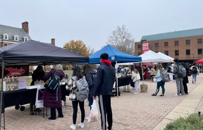 Students lining up in front of a farmers market stand