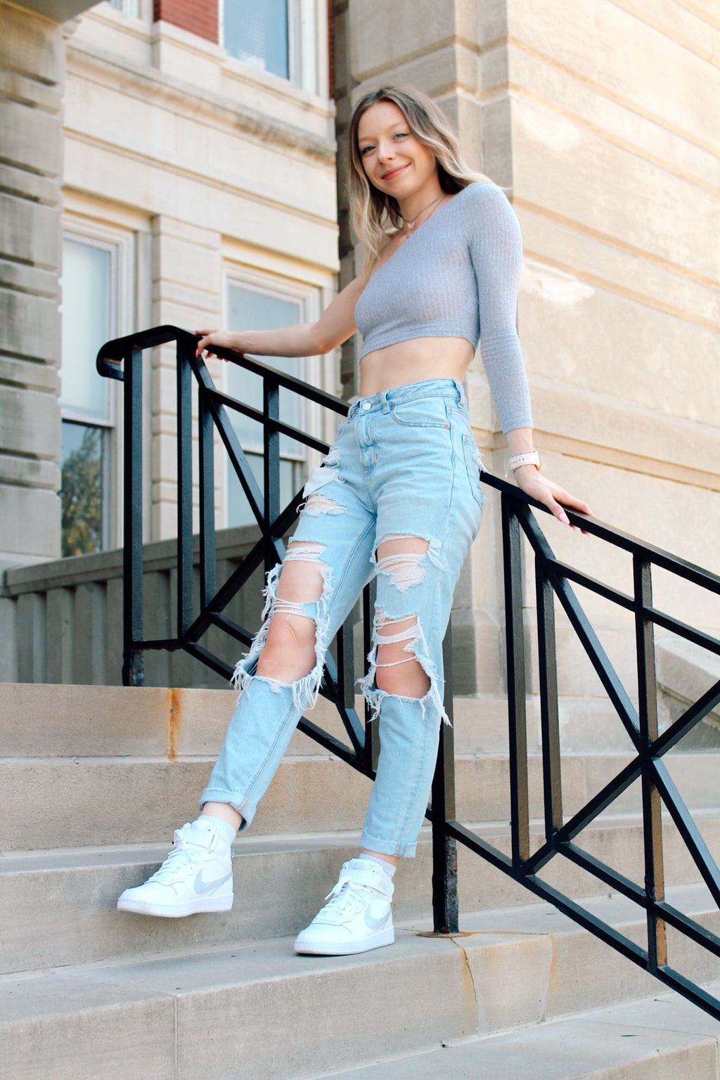 Woman on steps posing for camera