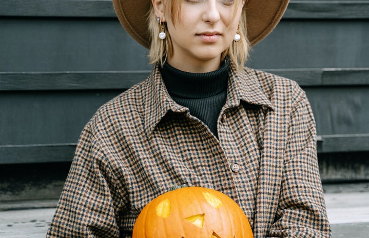 woman holding pumpkin and wearing fedora by Ivan Samkov?width=719&height=464&fit=crop&auto=webp