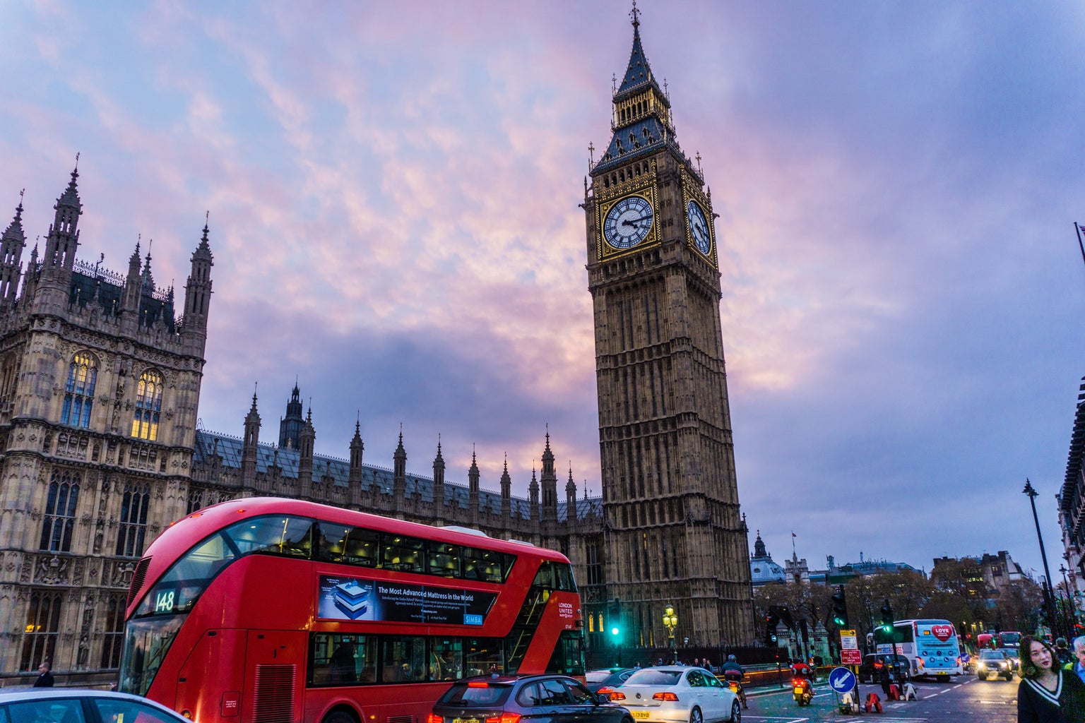 Big Ben in London, UK with a red bus in front