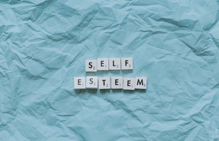 SELF ESTEEM written in Scrabble letters against a blue background