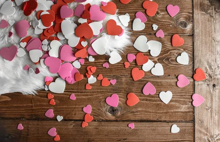 Heart shaped confetti on wooden floor