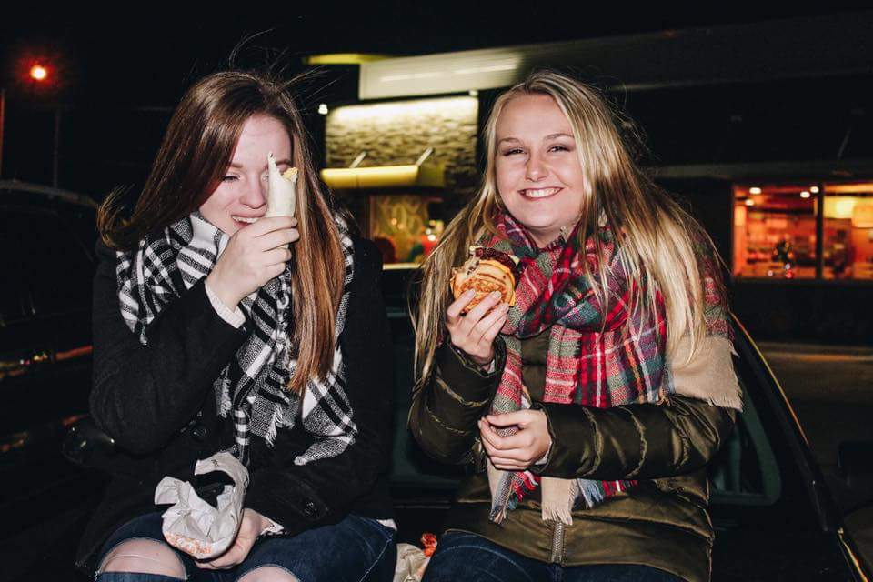 two girls eating fast food