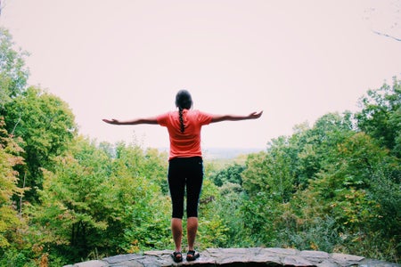 girl with arms open in nature