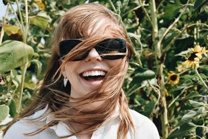 anna thetard happy girl smile hair blowing windy sunflowers red hair?width=698&height=466&fit=crop&auto=webp