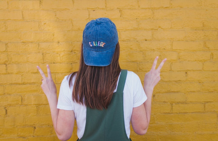 anna thetard girl with blue college cap yellow wall?width=719&height=464&fit=crop&auto=webp