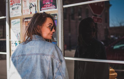 girl with jean jacket in front of shop