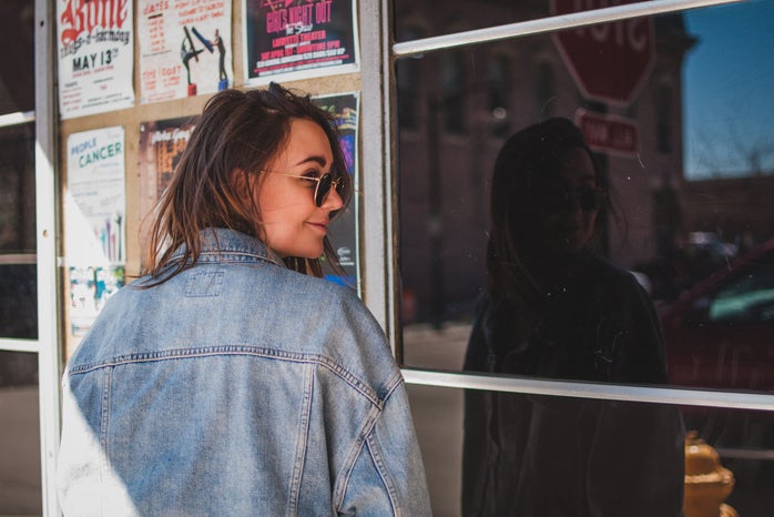 taylor thoman girl with jean jacket in front of shop?width=698&height=466&fit=crop&auto=webp