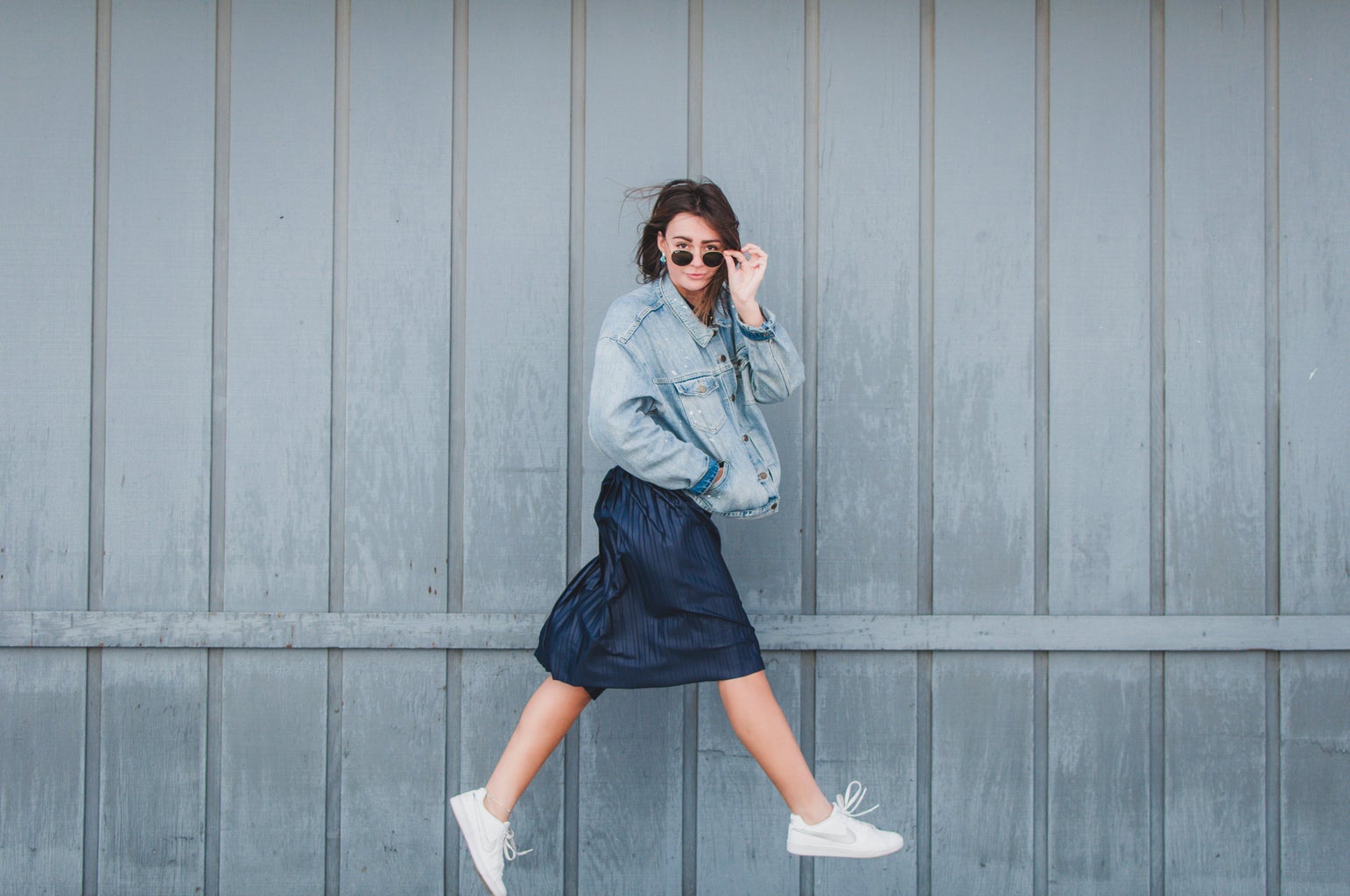 girl with jean jacket and skirt jumping 1