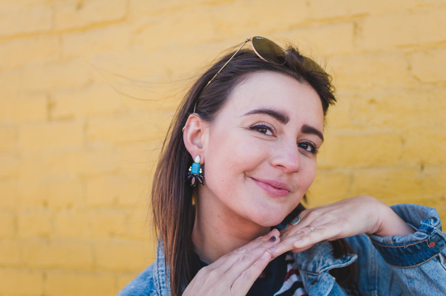 girl with jean jacket yellow wall