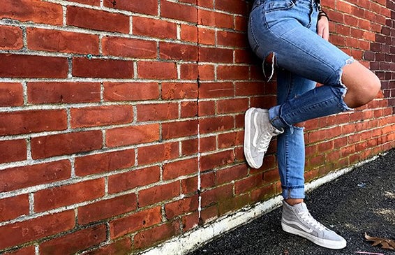 Meredith Kress brick wall ripped jeans leg up?width=719&height=464&fit=crop&auto=webp