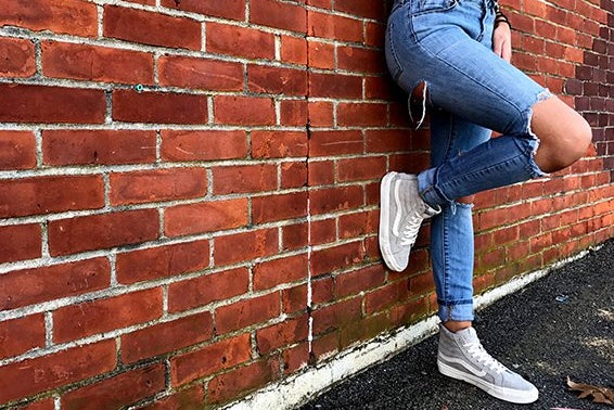 Meredith Kress brick wall ripped jeans leg up?width=698&height=466&fit=crop&auto=webp