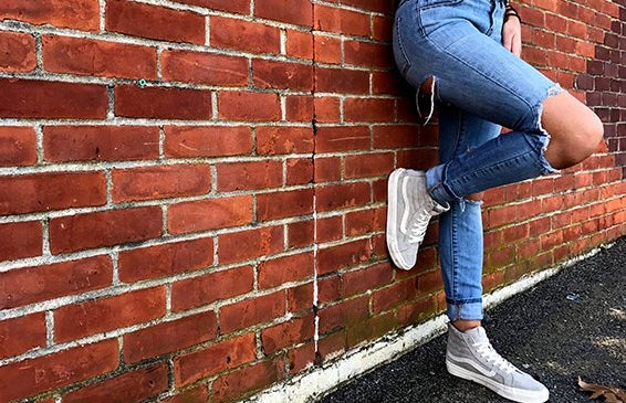 Meredith Kress brick wall ripped jeans leg up?width=719&height=464&fit=crop&auto=webp