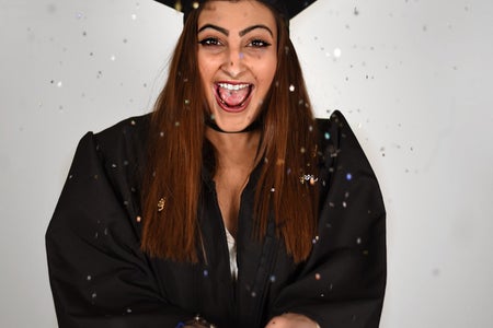Graduate Celebrating With Confetti