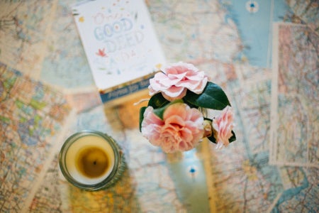 Candle And Flowers On Maps
