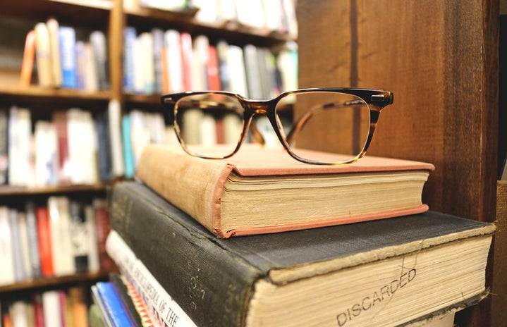 the lala stack of old books and glasses?width=719&height=464&fit=crop&auto=webp