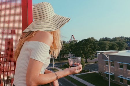 Anna Schultz-Girl In Sunhat With Wine Glass On Balcony