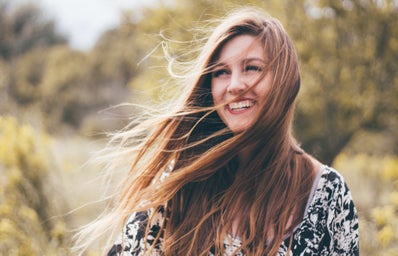 Girl Smiling With Wind Blowing Hair