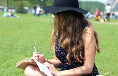 Kellyn Simpkin-Hat Girl Writing Book Grass Outside