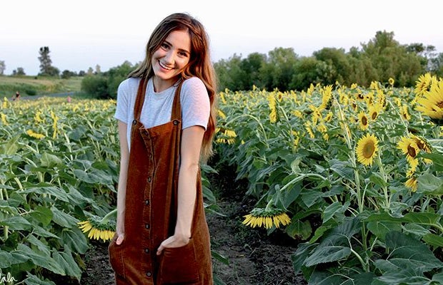Maria Scheller brunette happy girl sunflower field dress hands in pockets?width=719&height=464&fit=crop&auto=webp