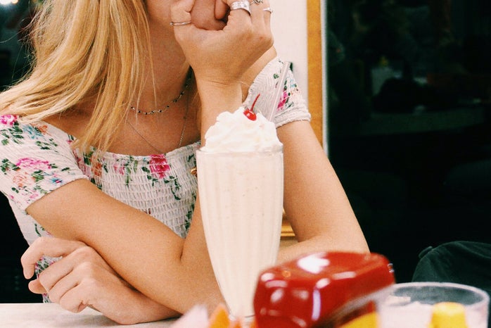 Anna Schultz girl sitting at diner with milkshake pondering?width=698&height=466&fit=crop&auto=webp