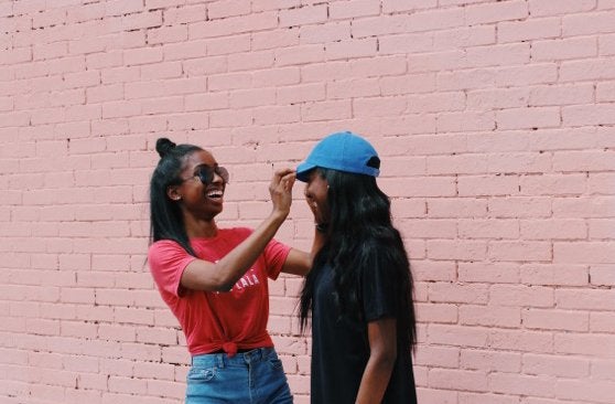 Anna Schultz-Girls Hat Laughing Friends Coral Wall