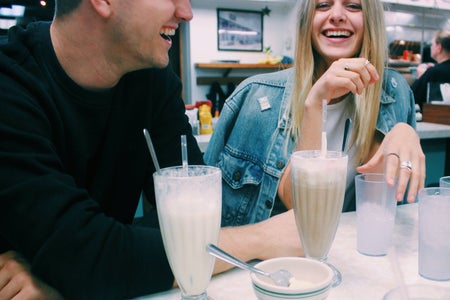 Anna Schultz-Girl And Guy Couple Laughing With Milkshakes