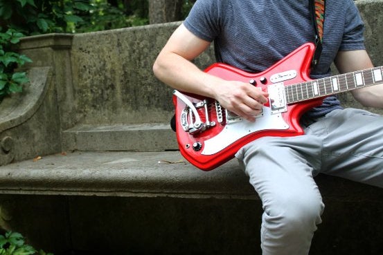 charlotte reader guy red guitar plants outside bench summer?width=698&height=466&fit=crop&auto=webp