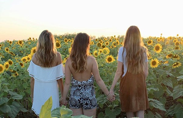 Maria Scheller friends backs hair holding hands sunflowers summer?width=719&height=464&fit=crop&auto=webp