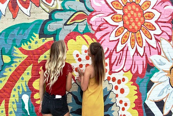Maria Scheller two girls friends long hair blonde and burnette flower mural?width=698&height=466&fit=crop&auto=webp