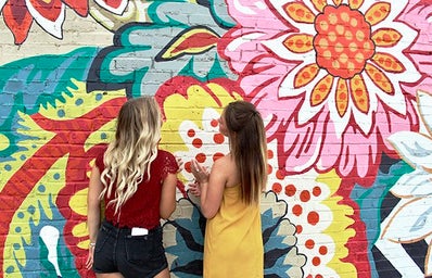 Maria Scheller-Two Girls Friends Long Hair Blonde And Burnette Flower Mural