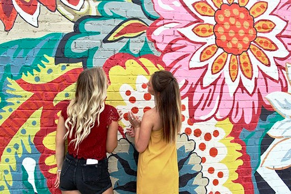 Maria Scheller two girls friends long hair blonde and burnette flower mural?width=698&height=466&fit=crop&auto=webp