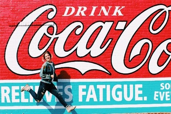 Amelia Kramer girl jumping in front of coca cola mural?width=698&height=466&fit=crop&auto=webp