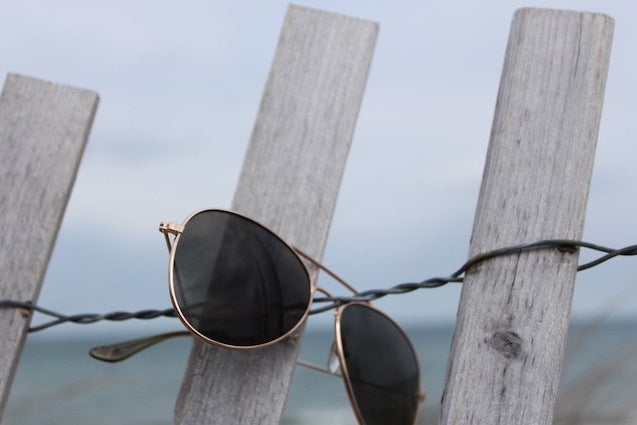 the lala aviator glasses on a fence?width=698&height=466&fit=crop&auto=webp