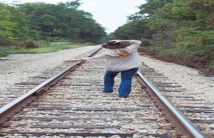 the lala girl walking down train tracks?width=719&height=464&fit=crop&auto=webp