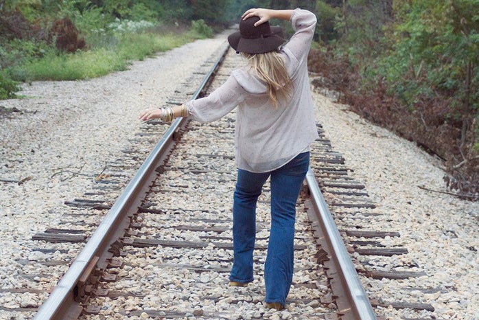 the lala girl walking down train tracks?width=698&height=466&fit=crop&auto=webp