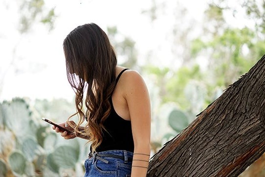 Kellyn Simpkin-Girl Scrolling Phone High Waisted Jeans Watch Curly Hair Cactus