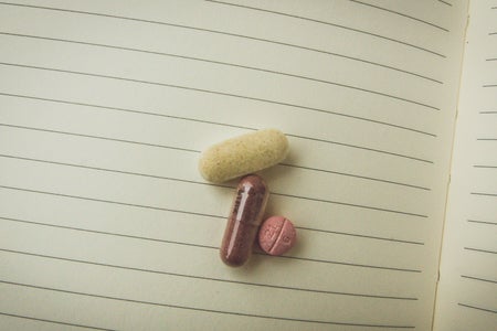 Kristen Bryant-Close Up Pills On Notebook