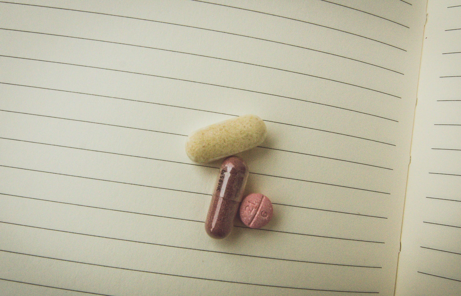 Kristen Bryant-Close Up Pills On Notebook