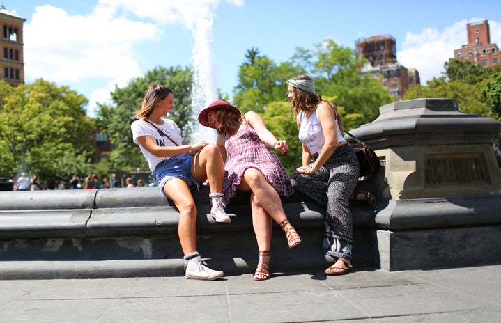 the lala three girls sitting by a fountain?width=719&height=464&fit=crop&auto=webp