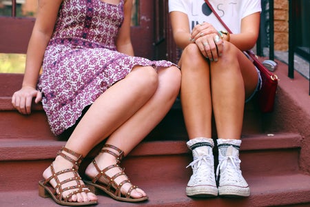 The Lalatwo Girls Sitting On A Step