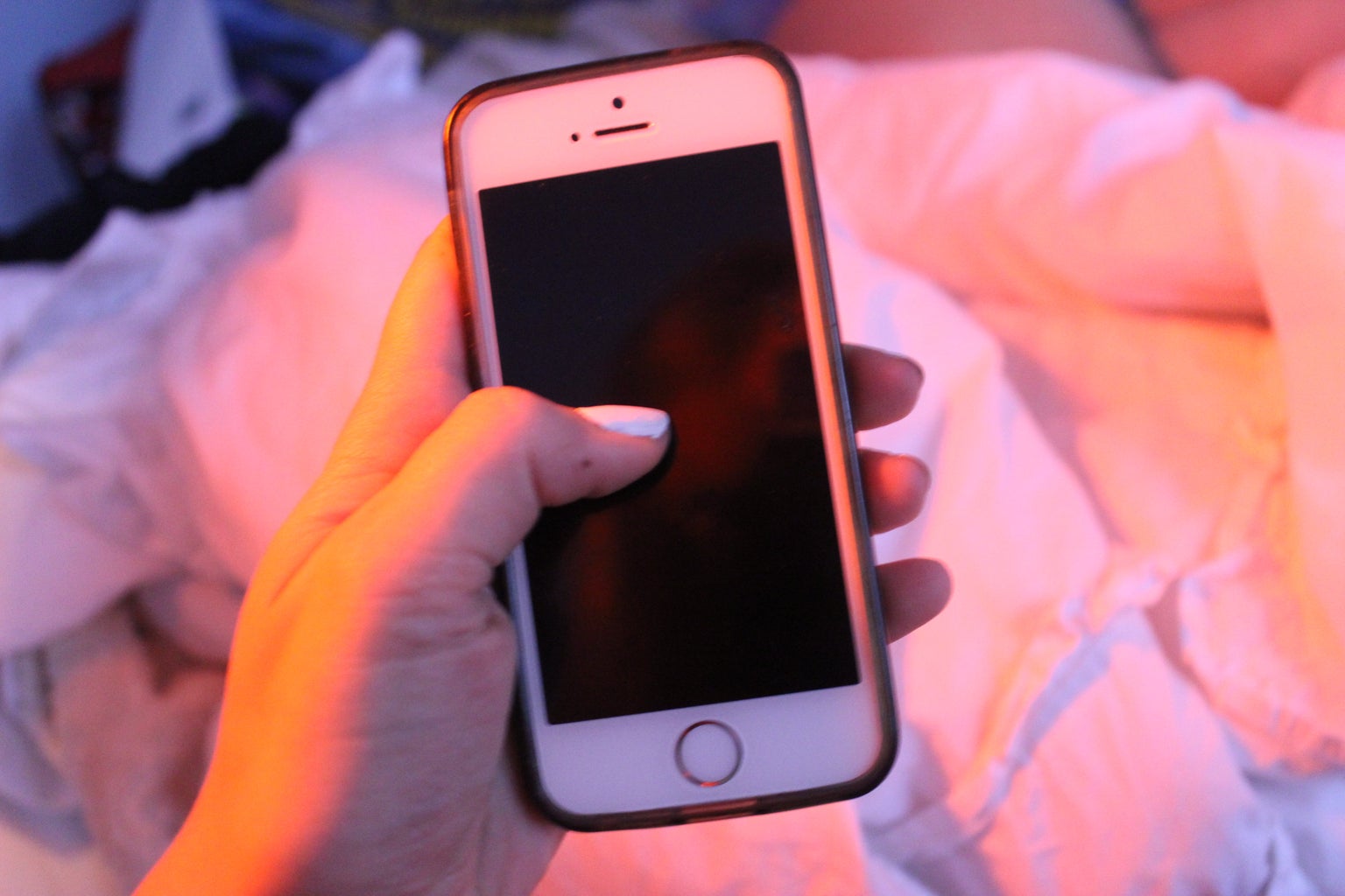 Anna Schultz-Hand Holding Iphone In Pink Lighting