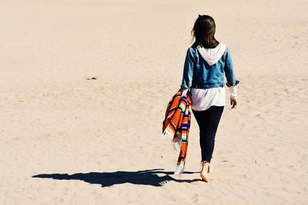 Girl At The Beach Walking With Blanket