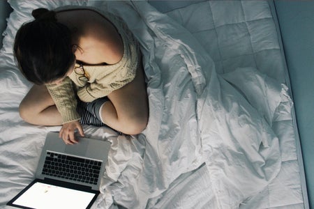 Anna Schultz-Girl Using Laptop In Cozy Bed