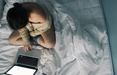 Anna Schultz-Girl Using Laptop In Cozy Bed