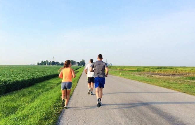 Three People Running In The Countryside